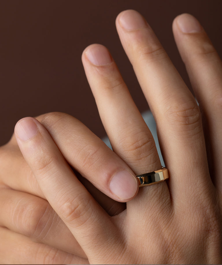 Photo showcases the Melanie Casey Men's Boderline Band on his hand.