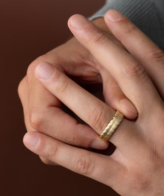 Photo showcases a model wearing the Melanie Casey Men's Terrain Ring on his hand.