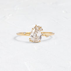 Photo showcases the To A Flame Ring 0.81ct Natural Champagne Diamond on a textured white background.