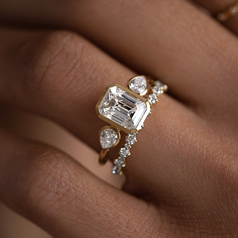 The Melanie Casey Bezel Set Undercurrents Ring, Emerald Cut shown being worn by a model.